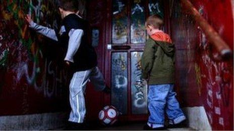 Boys play football in doorway