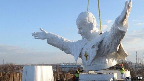 Workers put together elements of a 13.8m tall sculpture of the late Pope John Paul II in Czestochowa, southern Poland, 7 April 2013