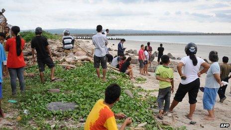 People gather near the airport in Denpasar, Bali, 13 April