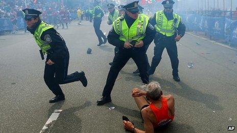 A runner lies on the ground after the Boston blast, 15 April