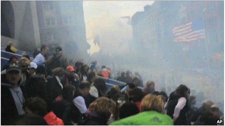 Smoke from the second Boston blast as spectators attempt to escape