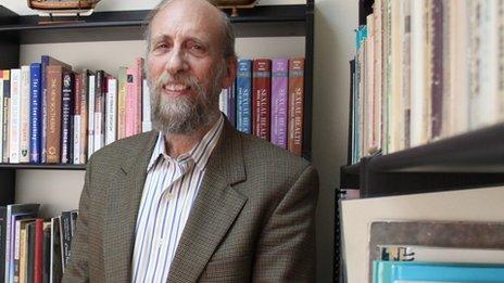 David Ribner in front of his bookcase at his office in Jerusalem