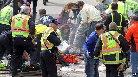 Medical workers aid injured people at the 2013 Boston Marathon following an explosion in Boston, Monday, April 15, 2013