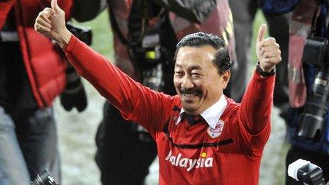 Cardiff City owner Vincent Tan celebrates on the pitch at the Cardiff City Stadium