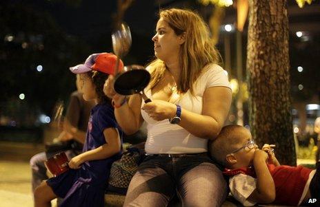 An opposition supporter bangs a pan to protest against the official presidential election results in Caracas, Venezuela, 16 April