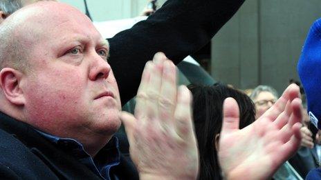 A man claps as Margaret Thatcher passes by