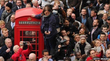 Crowds gather before the cortege passes along Fleet Street towards St Paul"s Cathedral on April 17, 2013 in London, England