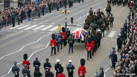 Crowds gather to watch as a Gun Carriage of The King"s Troop Royal Horse Artillery carries the coffin of Former British Prime Minister Baroness Thatcher as it leaves St Clement Danes Church