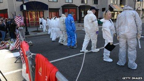 FBI crime scene investigators sweep up Boylston Street. 17 April 2013