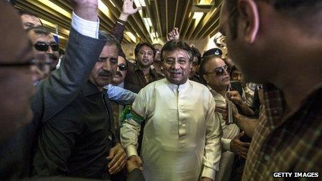 Former Pakistani president Pervez Musharraf is greeted by supporters after landing on Pakistani soil at Jinnah International airport on 24 March 2013 in Karachi