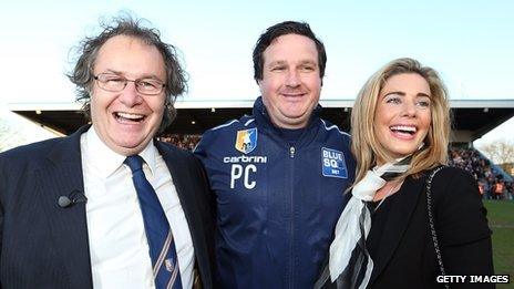 John Radford the Chairman of Mansfield Town celebrates with Manager Paul Cox and his wife Caroline Radford