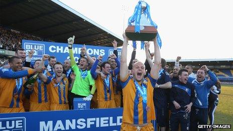 Adam Murray of Mansfield lifts the trophy