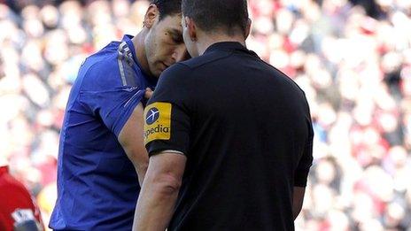 Chelsea's Branislav Ivanovic shows his arm to referee Kevin Friend