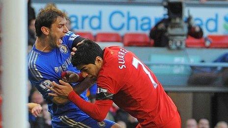 Luis Suarez tussles with Branislav Ivanovic