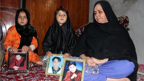 Ruqsana Bibi with photos of her three sons killed by a suicide bomber in Quetta