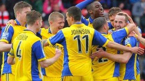 Kidderminster Harriers players celebrate James Vincent's opening goal at the Racecourse Ground