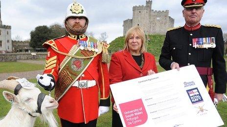 Professor Julie Lydon, vice-chancellor of the University of South Wales and Col Kevin Davies, deputy commander of the Army's 160 Wales Brigade with Shenkin the goat and his Army handler