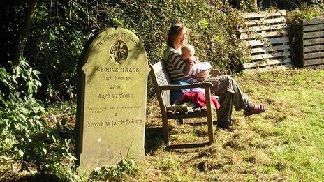 Woman and baby in churchyard