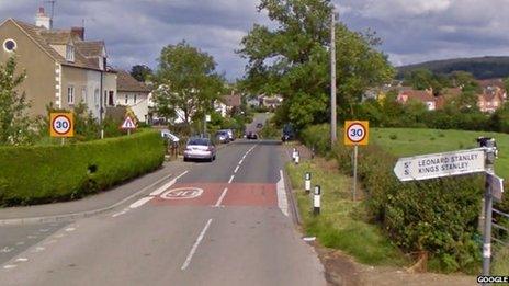 Village road with Leonard Stanley sign