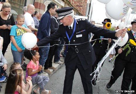 Policeman hands out balloons in Manchester