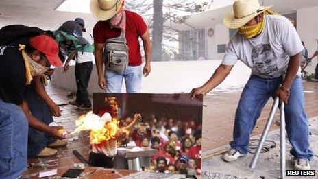 A group of teachers burn a picture of Mexico President Enrique Pena Nieto as they attack the offices of the ruling PRI to protest against an education overhaul in Chilpancingo, Guerrero state, Mexico, on Wednesday