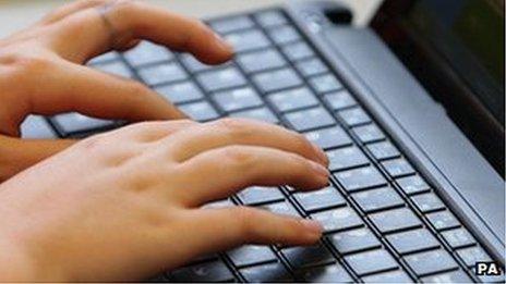 Hands placed on a computer keyboard