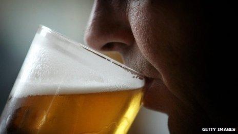 man drinking pint