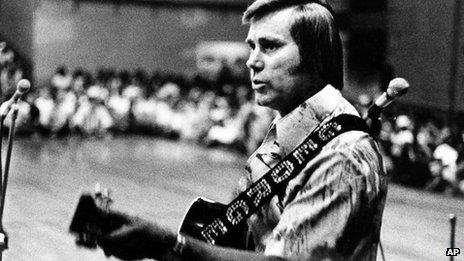 In this undated photo, country singer George Jones is shown performing with his guitar