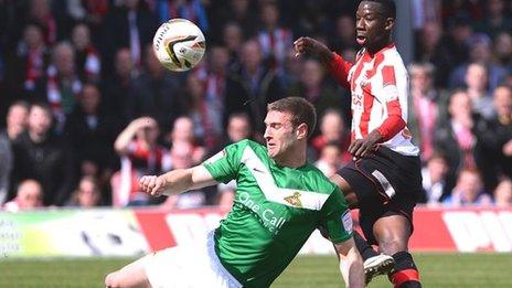 Doncaster's Jamie McCombe and Brentford's Bradley Wright-Phillips tussle at Griffin Park