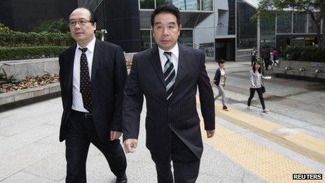 Birmingham City Football Club owner Carson Yeung (R) arrives at a district court in Hong Kong on Monday to answer money-laundering charges