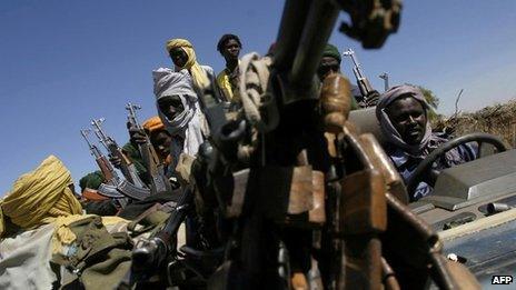 Members of Sudan Liberation Army (SLA), one of the groups in the local rebellion, arrive for a meeting with the African Union ceasefire commission in Tabit town, south of the city of al-Fasher, to hand over a thief arrested by the SLA, 01 December 2004