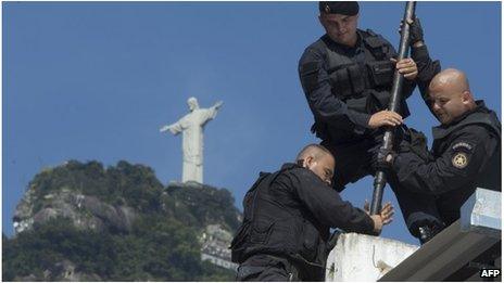 Police prepare flag pole in Rio favela