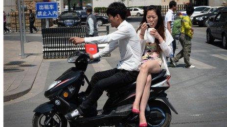 Chinese couple on a bike