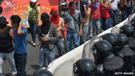 Teachers and students protest in front of anti-riot policemen in Acapulco