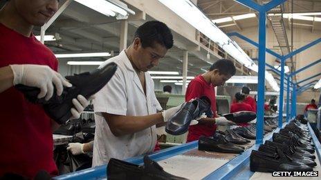 Men work on an assembly line at a Mexican shoe factory