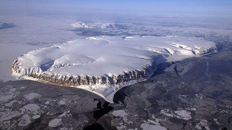 Saunders Island and Wolstenholme Fjord with Kap Atholl in the background is shown in this picture taken during an Operation IceBridge survey flight in April 2013