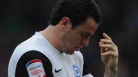 Peterborough's Lee Tomlin looks dejected after his side's relegation