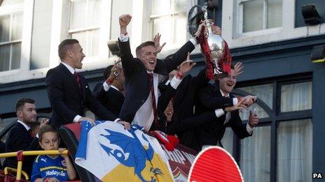 Cardiff City"s Craig Noone, Mark Hudson and Aron Gunnarsson with the cup