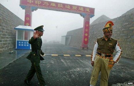 In this photograph taken on July 10, 2008, a Chinese soldier (L) and an Indian soldier stand guard at the Chinese side of the ancient Nathu La border crossing between India and China.