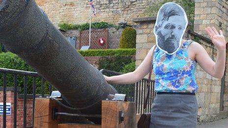 A fan wears a Lawrence mask at Lincoln Castle