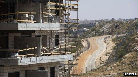 A builder works on a block of flats at a Jewish settlement near Jerusalem known as Har Homa (7 May 2013)