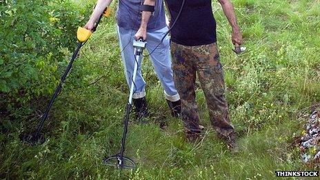 People metal detecting