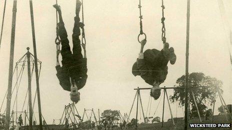 Boys upside down on playground equipment