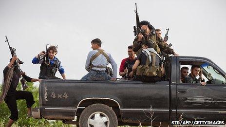 Members of Free Syrian Army patrol Qusayr, near Homs, on 10 May 2012