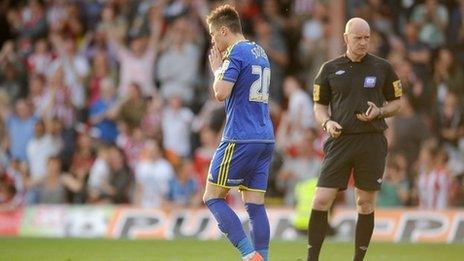 Miles Storey reacts to missing a penalty against Brentford