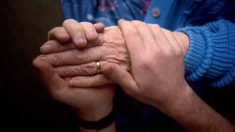 Woman being helped by carer