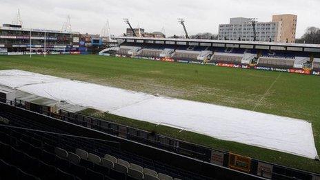 A muddy Cardiff Arms Park covered with plastic