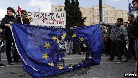 Greek students burn a EU flag