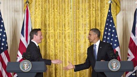 President Barack Obama and British Prime Minister David Cameron reach to shake hands at the end of their joint news conference 13 May 2013