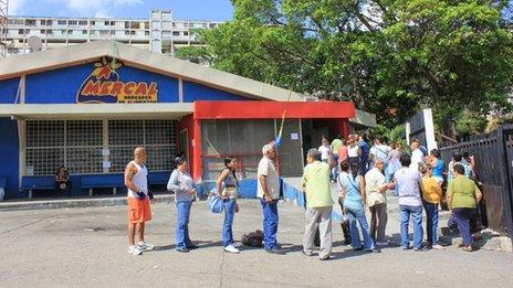 People queuing outside a Mercal supermarket